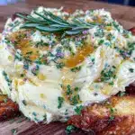 creamy butter board with honey and fresh herbs - featured image